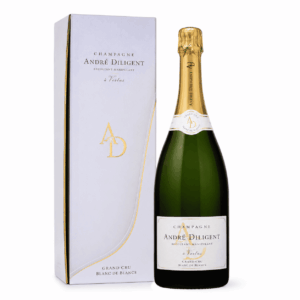 Une bouteille de MAGNUM DE CHAMPAGNE ANDRÉ DILIGENT (Brut Blanc de blanc, 150 cl) trône à côté de son élégant coffret blanc et or, tous deux ornés d'un logo raffiné et de détails dorés.