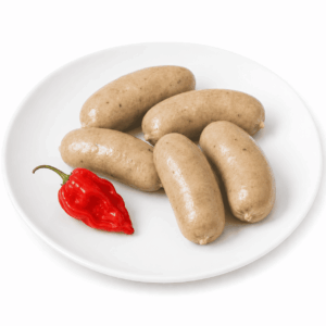 Six morceaux de BOUDIN AU CRABE sont disposés sur une assiette blanche, sur un fond blanc.